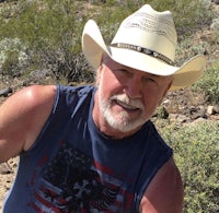 a man wearing a cowboy hat in the desert